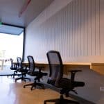 An office with several desks and chairs.