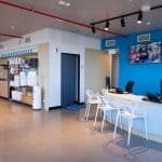 The reception area of a large office with blue walls.