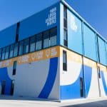 A blue and yellow building with a sign on it.