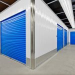 A storage unit with blue doors and white walls.