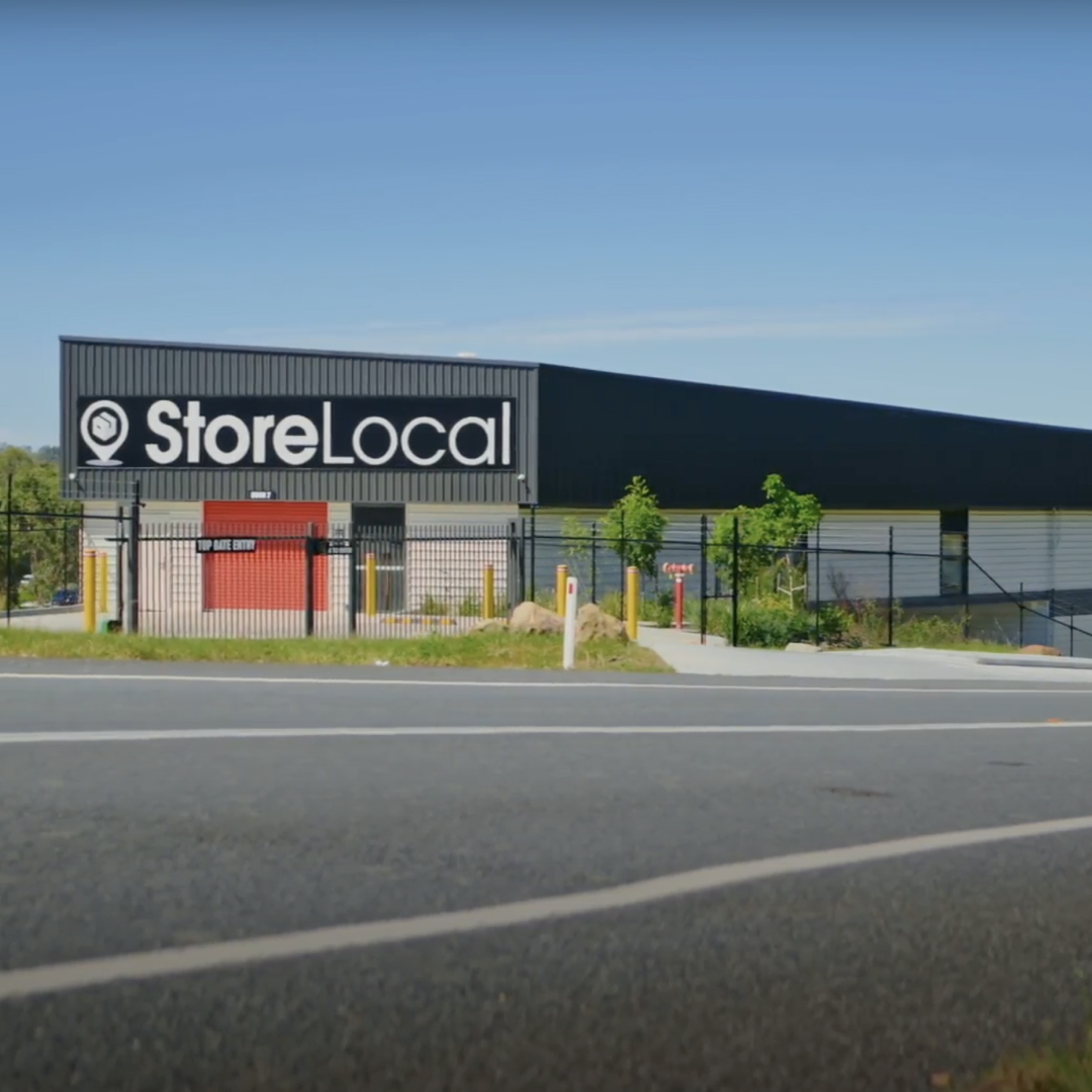 A black and white building with the words store local on it - showing level 1 vehicle access