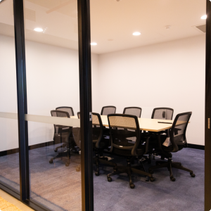 A conference room with a table and chairs.