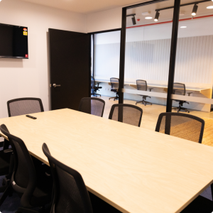 A conference room with a table and chairs.